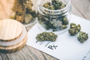 medical cannabis in jar on prescription pad