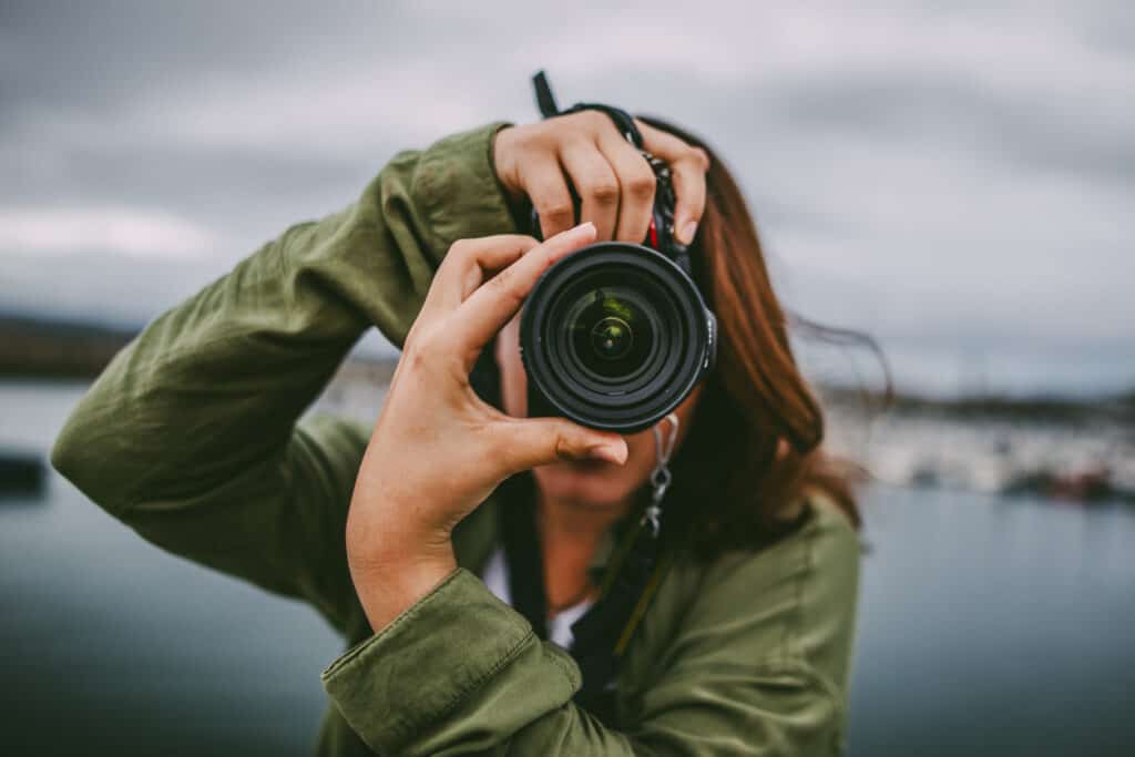 nature photographer pointing lens at camera